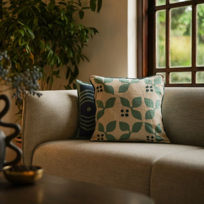 Margosa throw pillow with Blue Odai throw pillow by Kohomba Life on a sofa.