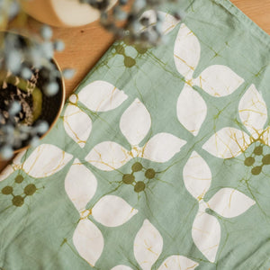 Margosa handmade cotton batik throw pillow in ivory on khaki green, 18" x 18", by Kohomba Life – close-up view.