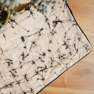 Thaalam handmade cotton batik decorative throw pillow in black on rye, 18" x 18", by Kohomba Life – close-up view.